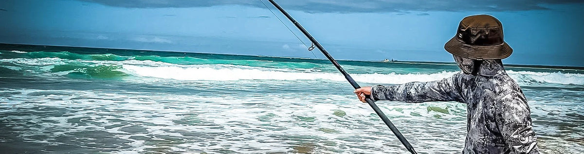 Surfcaster fishing with an Assassin rod on a surf beach