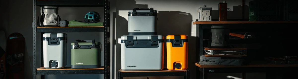 Dometic Recon coolers and water jugs on garage shelving