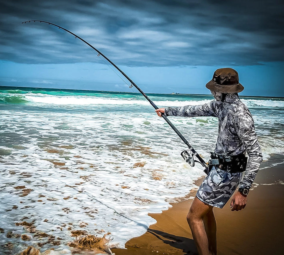 Surfcaster fishing with an Assassin rod on a surf beach