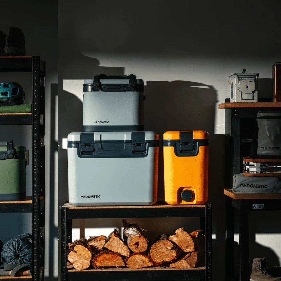 Dometic Recon coolers and water jugs on garage shelving