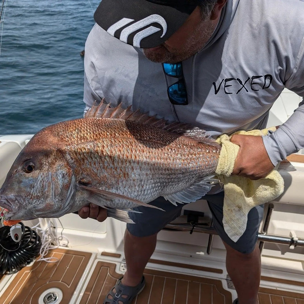 Angler holding a big snapper caught on a Vexed Bottom Meat